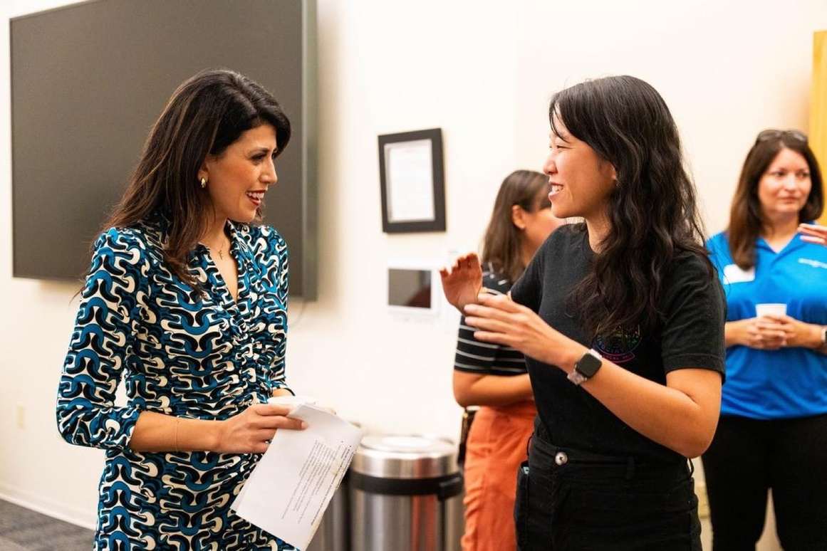 Selena Xie talking with a community member