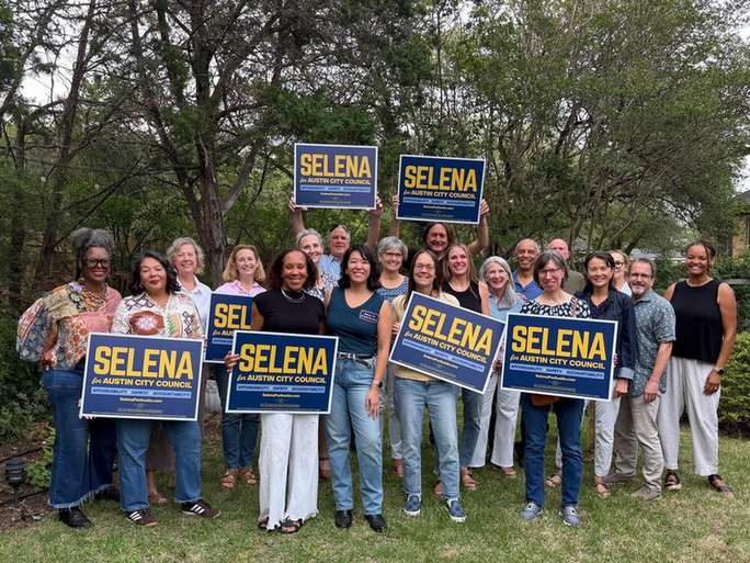 Supporters holding Selena for Austin City Council yard signs