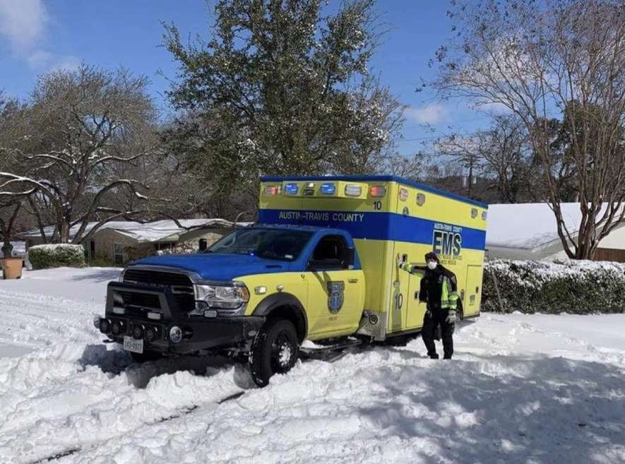 An Austin-Travis County EMS ambulance in the snow during Winter Storm Uri